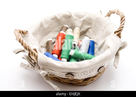Different sewing cotton in the basket Stock Photo