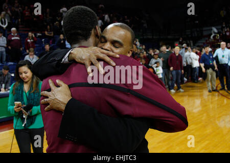 March 14, 2015: Harvard Crimson head coach Tommy Amaker gives guard Wesley Saunders (23) a hug following the NCAA basketball game between the Yale Bulldogs and the Harvard Crimson at the Palestra in Philadelphia, Pennsylvania. The Harvard Crimson won 53-51 to win the Ivy League Playoff game. Stock Photo