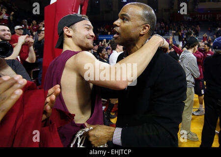 March 14, 2015: Harvard Crimson head coach Tommy Amaker gets a hug from the student section following the NCAA basketball game between the Yale Bulldogs and the Harvard Crimson at the Palestra in Philadelphia, Pennsylvania. The Harvard Crimson won 53-51 to win the Ivy League Playoff game. Stock Photo