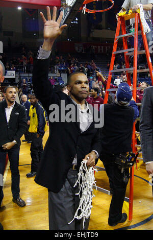 March 14, 2015: Harvard Crimson head coach Tommy Amaker waves to the fans after cutting down the net following the NCAA basketball game between the Yale Bulldogs and the Harvard Crimson at the Palestra in Philadelphia, Pennsylvania. The Harvard Crimson won 53-51 to win the Ivy League Playoff game. Stock Photo