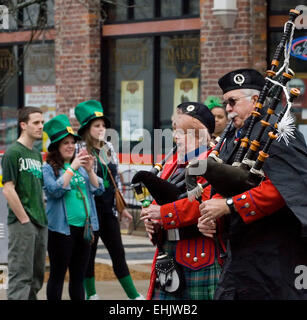Two pipers in the William Sutherland Reid Pipes and Drums band clad in ancient Scottish clan Sutherland tartan play the bagpipes while marching down Main Street in the 36th annual Alltech Lexington St. Patrick's Day Parade on Saturday, March 14, 2015 in Lexington, KY, USA. Originally incorporated in 1975 as the Lexington Pipe Band, the group's name was changed in 1993 to honor its founder. (Apex MediaWire Photo by Billy Suratt) Stock Photo
