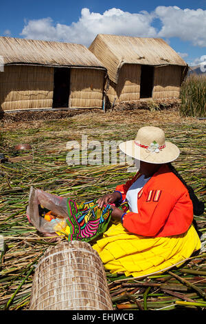 Near the town of Puno on the shore of Lake Titicaca visitors can see the Uros Islands and the villagers who live there. Stock Photo