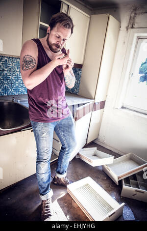 A young and exhausted redneck / rocker with hangover. Stock Photo