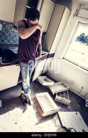 A young and exhausted redneck / rocker with hangover. Stock Photo