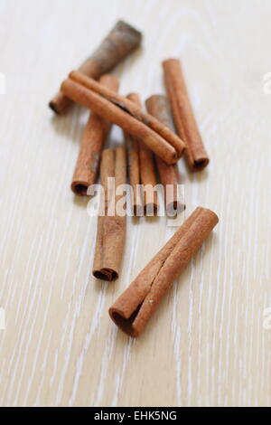 Cinnamon sticks on wooden board Stock Photo