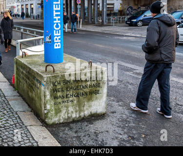 Concrete block supporting blue water drainage pipe inscribed with quotation by Elia Kazan - Mitte, Berlin Stock Photo