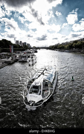 tourist boat on the seine river seen from the Bir-Hakeim bridge at the eiffel tower in paris Stock Photo