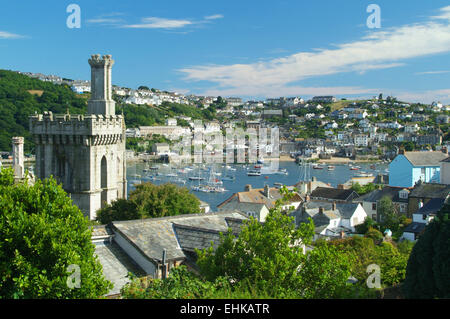 View over rooftops with the towers of 13th century Place House boats moored on the River Fowey & Polruan across the river Fowey Stock Photo