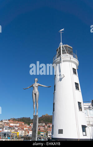 The Diving Belle sculpture and lighthouse outside Scarborough harbour, North Yorkshire, UK Stock Photo
