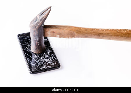 Hammer and smartphone with broken screen isolated on white. Stock Photo