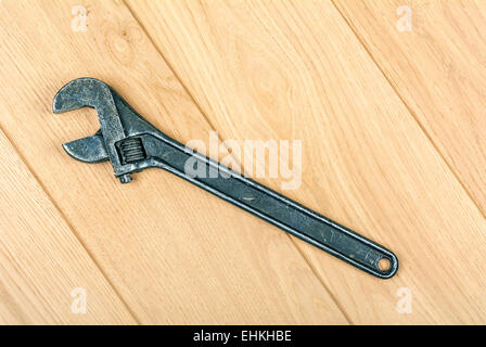 adjustable wrench embossed on the wooden floor Stock Photo