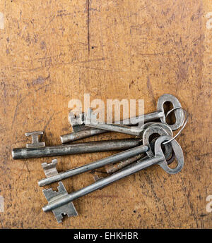 a bunch of old keys on a wooden art background Stock Photo
