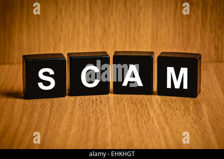 Scam, fraud text on black block, technology security concept Stock Photo