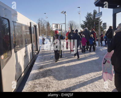 Skiers and sledge riders pouring out of the metro in Frognerseteren Oslo Norway ready for a day on the slopes Stock Photo