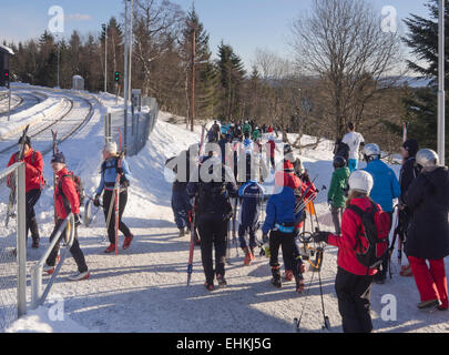 Skiers and sledge riders pouring out of the metro in Frognerseteren Oslo Norway ready for a day on the slopes Stock Photo