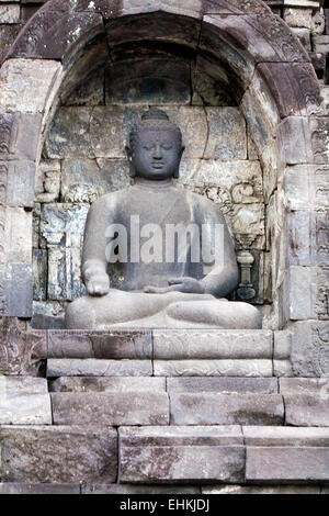 One of 504 Buddha statues of Borobudur Buddhist temple (IX cent.),   UNESCO World Heritage Site, Magelang,  Java, Indonesia Stock Photo