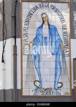 Painting on tiles Holy Mother Maria on a building wall in Corralejo Fuerteventura, Canary islands Spain Stock Photo