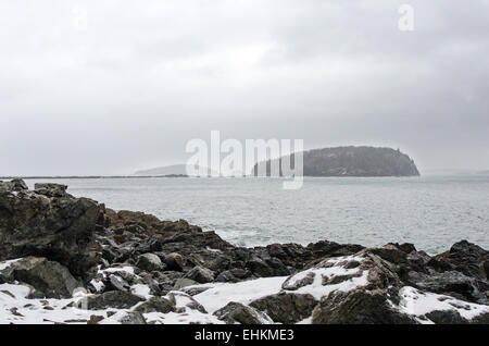 The view from Compass Harbor to Bald Porcupine Island on a rainy winter day in Acadia National Park, Bar Harbor, Maine Stock Photo
