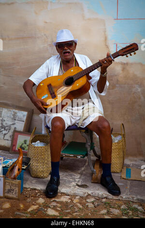 A musican plays on the street in Trinidad, Cuba Stock Photo