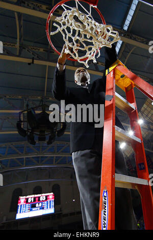 March 14, 2015: Harvard Crimson head coach Tommy Amaker cuts down the net following the NCAA basketball game between the Yale Bulldogs and the Harvard Crimson at the Palestra in Philadelphia, Pennsylvania. The Harvard Crimson won 53-51 to win the Ivy League Playoff game. Stock Photo