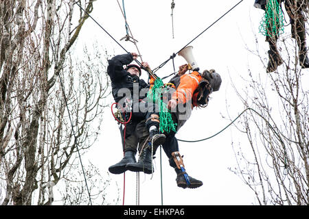 Bristol, UK. 15th Mar, 2015. An eviction climber cuts a protesters rope in order to remove him from the trees.  A fourth day of evictions from a protest site, occupied to prevent work starting on a Metrobus project, saw the tree-top camps cleared and protesters evicted. Bristol, UK. 15th March 2015. Credit:  Redorbital Photography/Alamy Live News Stock Photo