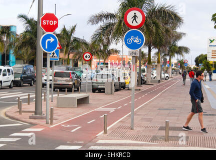 Pavement and bicycle lane with lots of signs directed at bikers, well adapted road system in Corralejo Fuerteventura, Spain Stock Photo