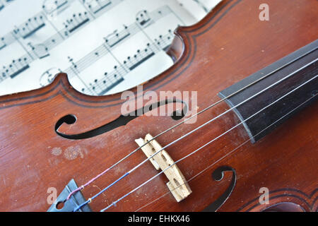 German ancient violin and notes. Old violin, copy of Majini made Saxony, in the 19th century. Stock Photo