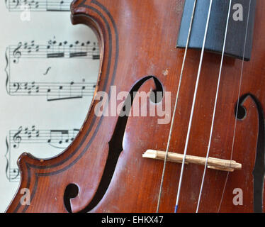 German ancient violin and notes. Old violin, copy of Majini made Saxony, in the 19th century. Stock Photo