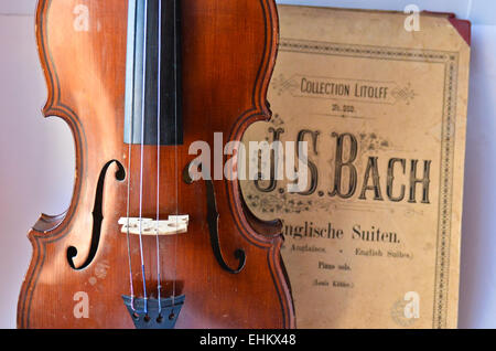 German ancient violin and notes. Old violin, copy of Majini made Saxony, in the 19th century. Stock Photo