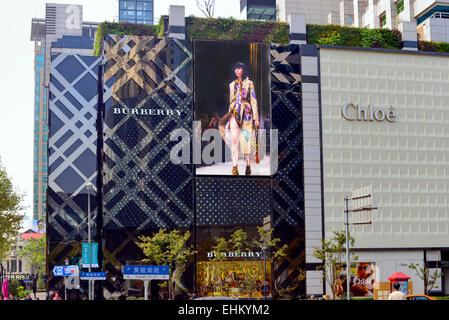Burberry store with screen featuring footage of models walking, and Chloe boutique on the fashionable Huangpi Road in Shanghai. Stock Photo
