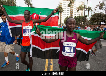 Los Angeles, USA. 15th Mar, 2015. Daniel Limo (2nd R) and Olga Kimaiyo (1st R) of Kenya, celebrate with their national flags after they won the 30th Asics LA Marathon in Los Angeles, California, the United States, March 15, 2015. About 26,000 runners from all 50 states and 55 countries participated in the 26.2-mile event, which began at Los Angeles Dodger Stadium and went through Los Angeles, West Hollywood and Beverly Hills and ended in Santa Monica. © Zhao Hanrong/Xinhua/Alamy Live News Stock Photo