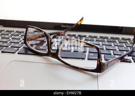 Reading glasses on laptop keyboard - USA Stock Photo