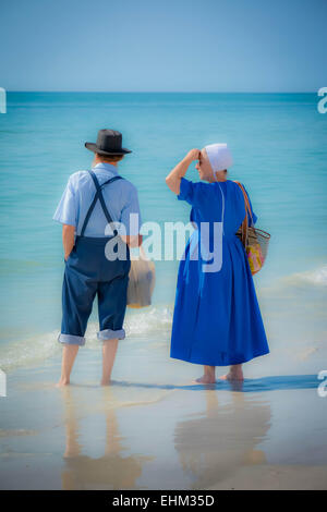 An Amish couple, dressed in their traditional manner paddle in the ...