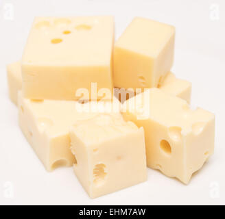 fresh cheese cubes on white plate Stock Photo