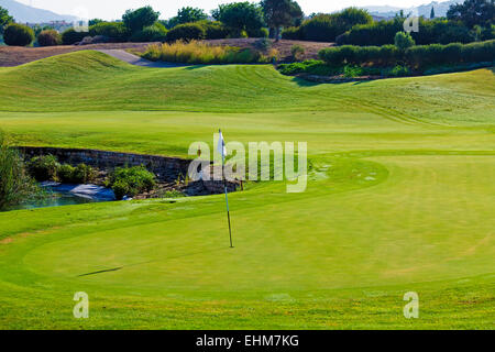 Putting green of golf field with flag,  Paphos, Cyprus Stock Photo