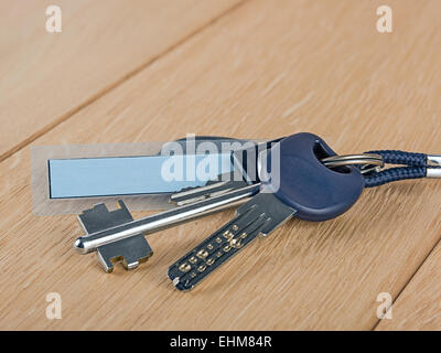 bunch of keys on a wooden table Stock Photo