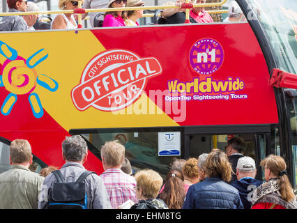 Tourists queuing for city sightseeing bus tour Stock Photo