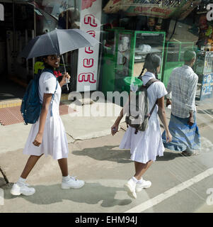 COLOMBO, SRI LANKA - DEC 7: Common Sri Lankian crowded street with Sri Lankan schoolgirls on Dec 7, 2011 in Colombo, Sri Lanka. Stock Photo