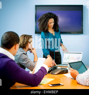 Businesswoman giving presentation in office meeting Stock Photo