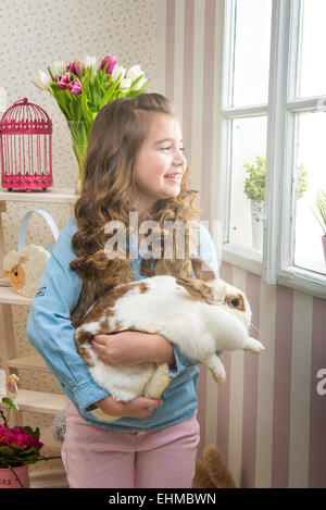 Easter - Little girl loves live rabbit Stock Photo