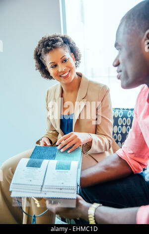 Business people examining swatches in office lobby Stock Photo