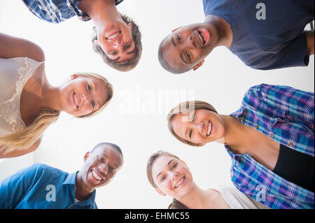 Low angle view of teenagers standing in circle Stock Photo