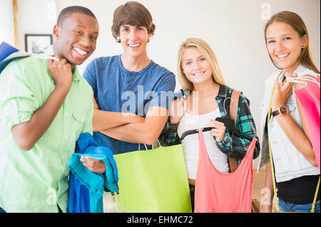 Smiling teenagers holding shopping bags Stock Photo