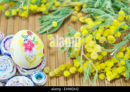 Hand painted decoupage Easter egg and mimosa flowers Stock Photo