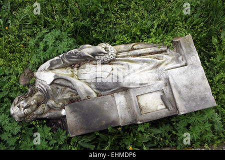 Fallen angel. Destroyed tombstone at an abandoned cemetery in Terezin, Czech Republic. Stock Photo