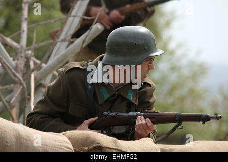 Re-enactor dressed as a German Nazi soldier attends the re-enactment of the Battle at Orechov (1945) near Brno, Czech Republic. The Battle at Orechov in April 1945 was the biggest tank battle in the last days of the World War II in South Moravia, Czechoslovakia. Stock Photo