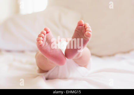 Close up of feet of mixed race baby Stock Photo