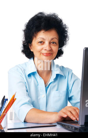 Elder woman using laptop on white background. Stock Photo
