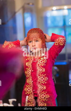 Caucasian girl wearing beaded cap Stock Photo