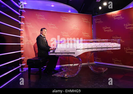 Berlin, Germany. 16th Mar, 2015. The wax figure of late Austrian singer Udo Juergens sits on a glass grand piano at Madam Tussauds in Berlin, Germany, 16 March 2015. The figure which exists in Vienna since 2013 will be placed at the glass grand piano of piano manufacturer 'Schimmel' in Berlin fro two month. The piano was specially made for and played by the deceased singer. Credit:  dpa picture alliance/Alamy Live News Stock Photo